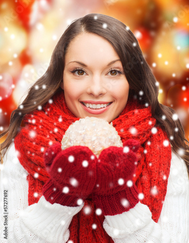 Photo: woman in scarf and mittens with christmas ball woman in scarf and mittens with christmas ball