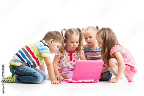 Photo: group of kids friends playing at the laptop group of kids friends playing at the laptop