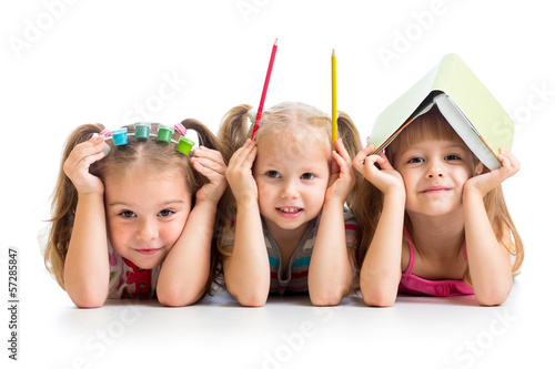 Photo: kids with book, pencils and paints on their heads kids with book, pencils and paints on their heads