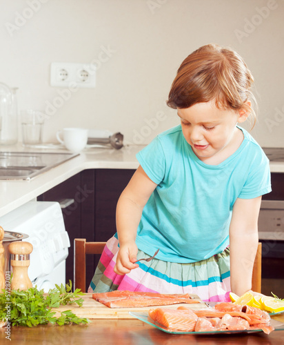 Photo: baby girl cooking salmon baby girl cooking salmon