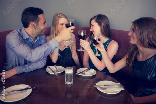 Photo: Smiling friends clinking wine glasses Smiling friends clinking wine glasses