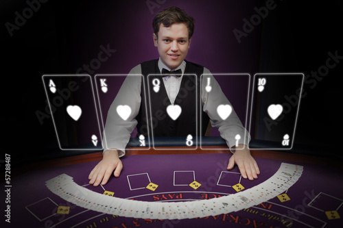 Photo: Picture of croupier standing behind holographic cards Picture of croupier standing behind holographic cards
