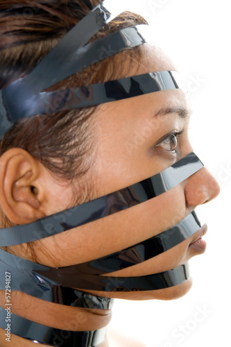 Photo: woman has a bandaged face with black tape.. woman has a bandaged face with black tape..