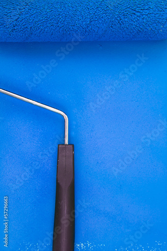Photo: Blue paint roller handle on a background Blue paint roller handle on a background