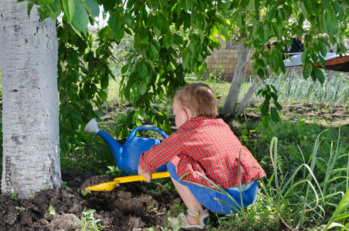 Photo: Little boy playing in the vegetable garden Little boy playing in the vegetable garden