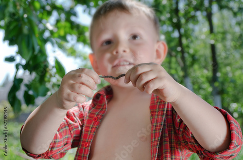 Photo: Little boy with an earthworm in his hands Little boy with an earthworm in his hands