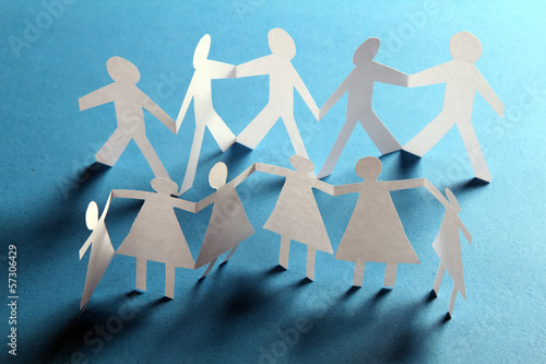 Photo: close up of paper people on white background close up of paper people on white background
