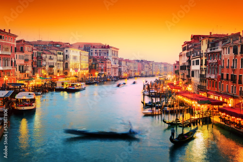 Fototapeta Venice, Italy. Gondola floats on Grand Canal at sunset