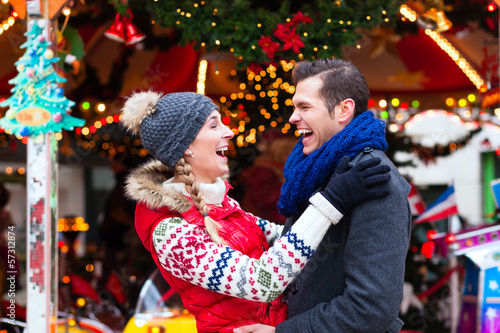 Photo: Couple during Christmas market or advent season Couple during Christmas market or advent season