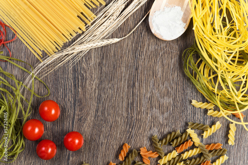 Photo: pasta, tomatoes and flour on the spoon pasta, tomatoes and flour on the spoon