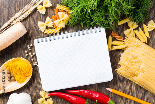 Photo: spices and vegetables around notebook spices and vegetables around notebook