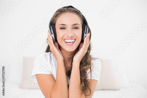 Photo: Happy attractive brunette listening to music Happy attractive brunette listening to music