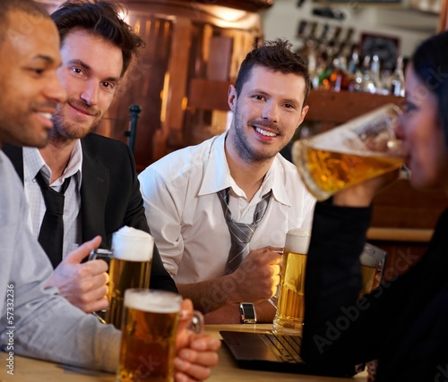 Photo: Group of friends drinking beer at pub Group of friends drinking beer at pub