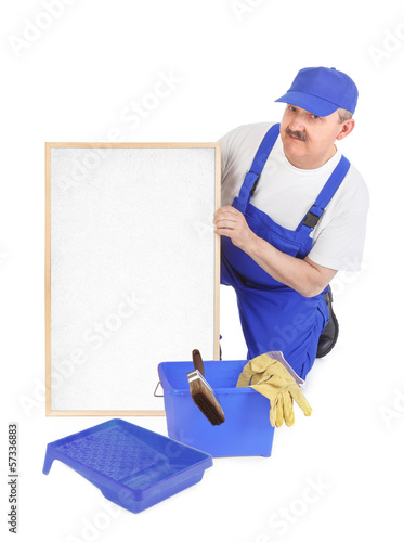 Photo: House painter and empty white board House painter and empty white board