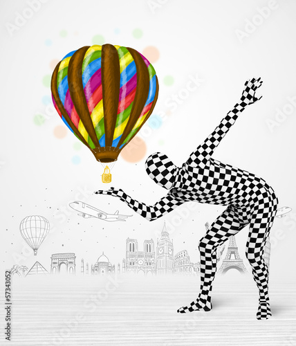 Photo: man in full body suit holding balloon man in full body suit holding balloon
