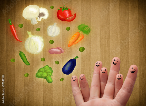 Photo: Happy smiley face fingers looking at illustration of colorful he Happy smiley face fingers looking at illustration of colorful he