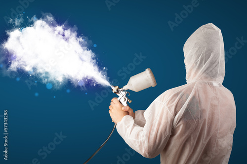 Photo: Painter with airbrush gun and white magical smoke Painter with airbrush gun and white magical smoke