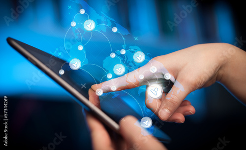 Photo: Hand touching tablet pc, social network concept Hand touching tablet pc, social network concept