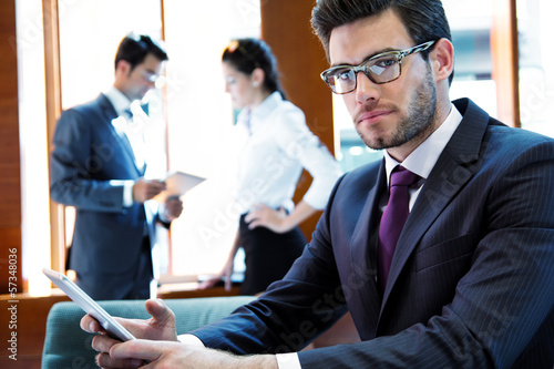 Photo: A business team of three in office and planning work A business team of three in office and planning work