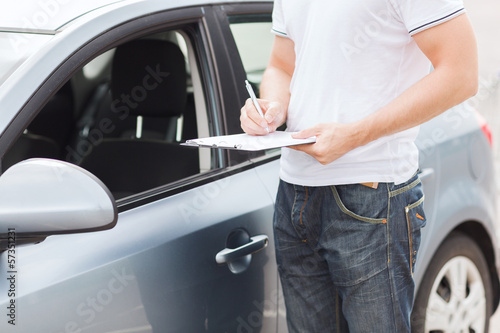 Photo: man with car documents man with car documents