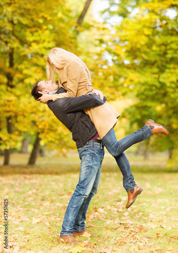 Photo: romantic couple playing in the autumn park romantic couple playing in the autumn park