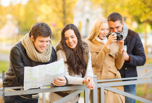 Photo: couples with tourist map and camera in autumn park couples with tourist map and camera in autumn park