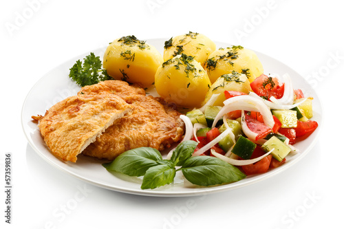 Photo: Fried pork chops, boiled potatoes and vegetable salad Fried pork chops, boiled potatoes and vegetable salad