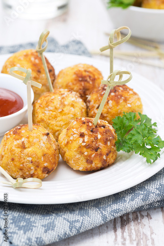 Photo: chicken meatballs in breading with tomato sauce, closeup chicken meatballs in breading with tomato sauce, closeup