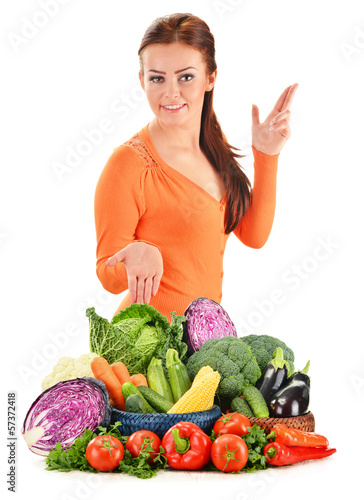 Photo: Young woman with assorted vegetables isolated on white Young woman with assorted vegetables isolated on white