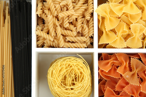 Photo: Different types of pasta in white wooden box sections close-up Different types of pasta in white wooden box sections close-up