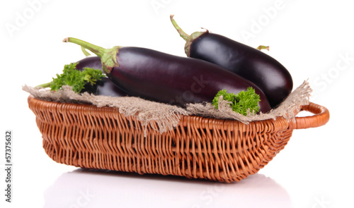 Photo: Fresh eggplants in wicker basket isolated on white Fresh eggplants in wicker basket isolated on white