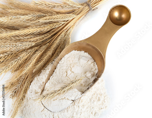 Photo: The wholemeal flour in scoop isolated on white The wholemeal flour in scoop isolated on white