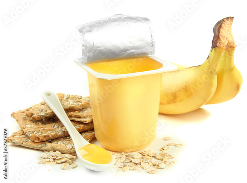 Photo: Tasty yogurt in open plastic cup, cookies and fruit, isolated Tasty yogurt in open plastic cup, cookies and fruit, isolated