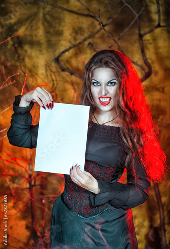 Photo: Halloween vampire holding sheet of paper Halloween vampire holding sheet of paper