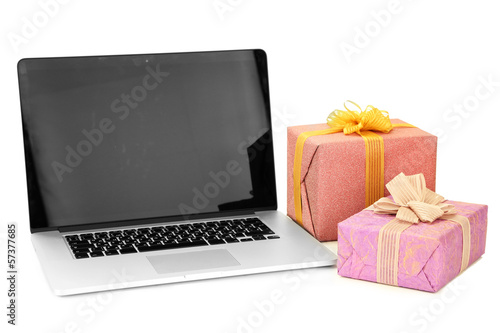 Photo: Modern notebook and gift boxes, isolated on white Modern notebook and gift boxes, isolated on white