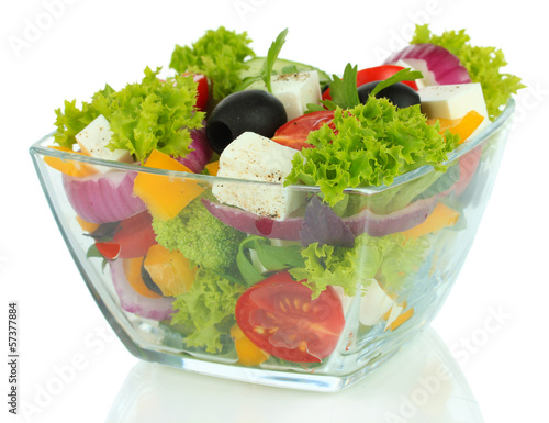 Photo: Greek salad on plate isolated on white Greek salad on plate isolated on white