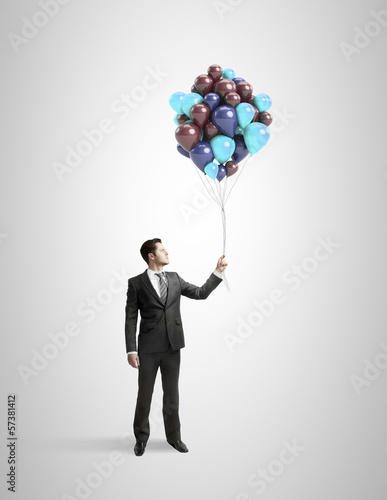 Photo: businessman holding baloons businessman holding baloons