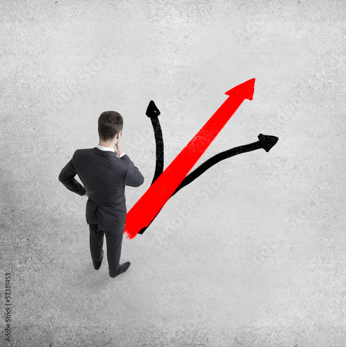 Photo: man looking at drawing arrow man looking at drawing arrow