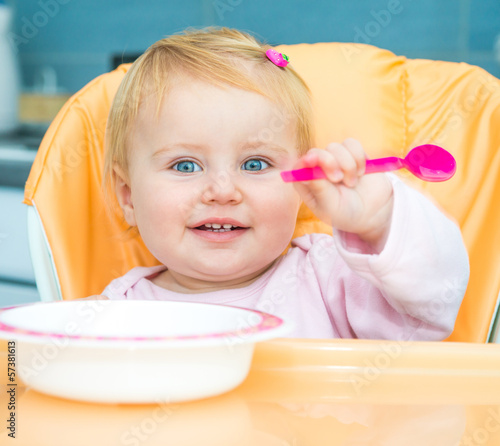 Photo: one year old girl in a highchair for feeding one year old girl in a highchair for feeding