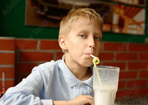 Photo: boy drinking milkshake boy drinking milkshake