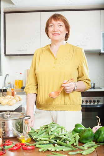 Photo: mature housewife with fresh okra mature housewife with fresh okra