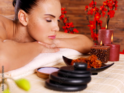 Photo: portrait of an adult beautiful woman relaxing in spa salon portrait of an adult beautiful woman relaxing in spa salon