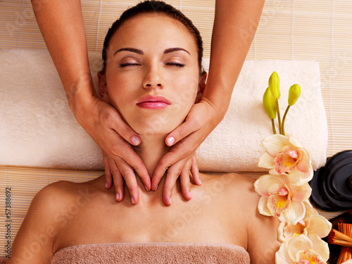 Photo: Masseur doing massage the neck of an woman in spa salon Masseur doing massage the neck of an woman in spa salon