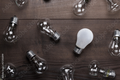 Photo: bulb uniqueness concept on the wooden table bulb uniqueness concept on the wooden table