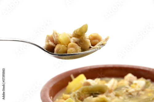 Photo: spoonful of stewed chickpeas with meat, beans and potatoes spoonful of stewed chickpeas with meat, beans and potatoes