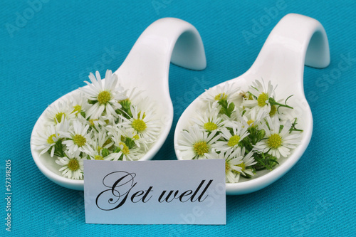Photo: Get well card with fresh chamomile flowers on blue background Get well card with fresh chamomile flowers on blue background