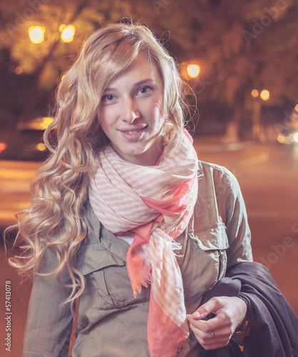 Photo: young female businesswoman in night city. young female businesswoman in night city.