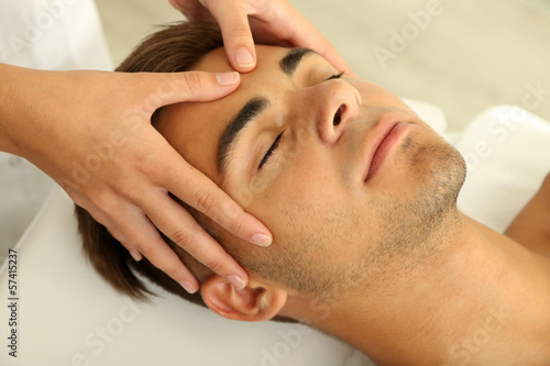 Photo: Man having head massage close up Man having head massage close up