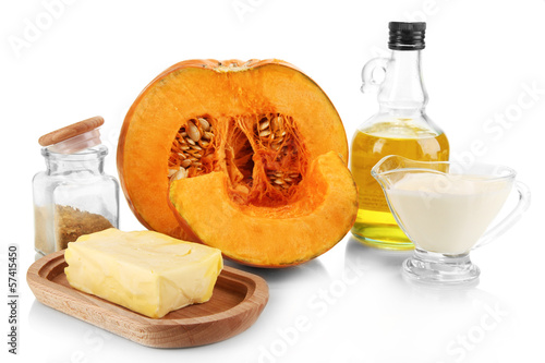 Photo: Cut pumpkin with ingredients for cooking isolated on white Cut pumpkin with ingredients for cooking isolated on white