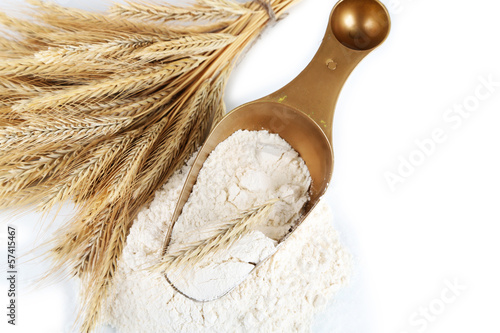 Photo: The wholemeal flour in scoop isolated on white The wholemeal flour in scoop isolated on white